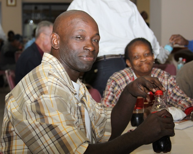 Sebastian Oliver, a former client and now volunteer, enjoys the reception that followed Camillus House's 50th anniversary Mass Jan. 19. When I was down and out they took me in, guided me in the right direction," he said.