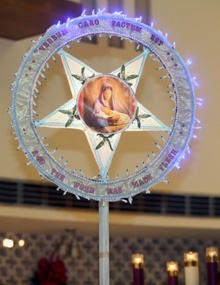 A parol -- an ornamental star-like Christmas lantern -- is a traditional part of the Simbang Gabi celebration in the Philippines. This one bears an image of Mary with baby Jesus.