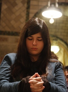 Immaculata La Salle High School student Arantza Eseverri, 16, spends some time in silent prayer during the Mass in the Crypt-level of the National Shrine of the Immaculate Conception.