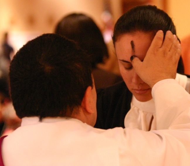 A woman receives ashes from Deacon Edgardo Faras during Ash Wednesday Mass Feb. 17 at St. Martha Parish in Miami Shores.