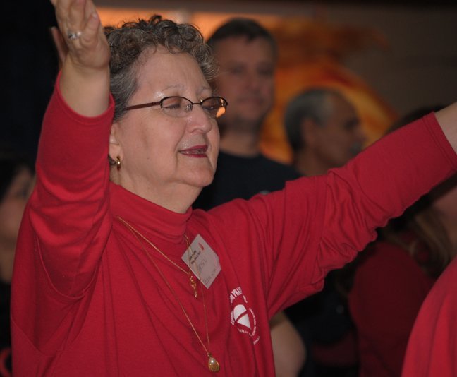 A woman named Carmen from the charismatic prayer group at St. John Neumann Parish in Miami prays during the annual Catholic Charismatic Conference, which drew about 500 people to Our Lady of Lourdes Parish in Miami Feb. 19-21.