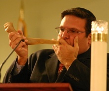 Rabbi Frederick Klein, executive vice-president of the Rabbinical Association of Greater Miami, opens the interfaith prayer service for Haiti by blowing on the shofar.