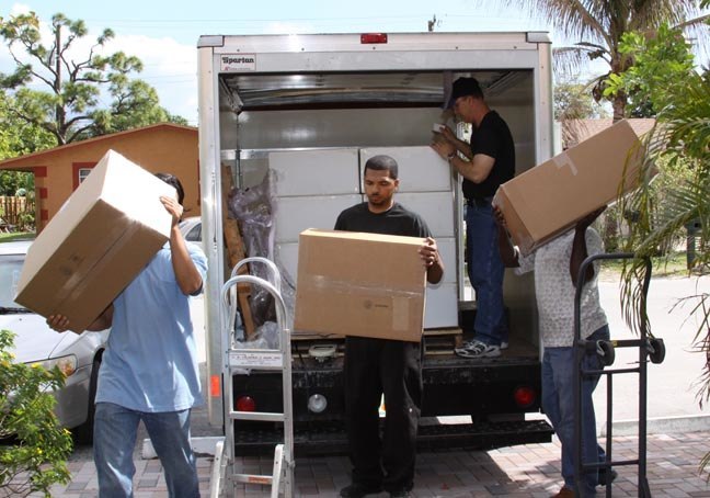 Volunteers help unload two truckloads of donated religious items worth approximately 0,000.