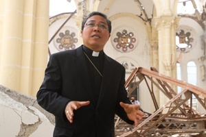 At the ruins of the Haiti cathedral, the papal nuncio, Archbishop Bernardito Auza, gives an explanation of the damages to a visiting delegation from the U.S. conference of bishops