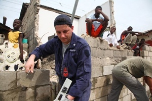 Members of the Italian Armed Forces help repair a security wall at a Salesian mission in Port-au-Prince. The government of Italy is funneling some of its aid to Haiti through the network of Salesian organizations.