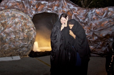 Women weep at the tomb of Jesus.