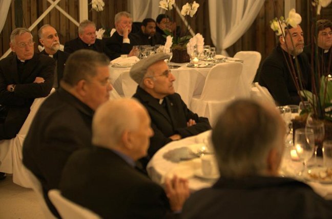 Priests listen to Archbishop John C. Favalora during the dinner that concluded the Year for Priests celebration hosted by Father Chris Marino and the staff of St. Michael Parish in Miami, with help from the Knights of Columbus.