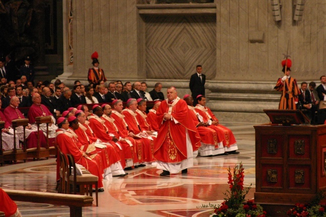 Archbishop Thomas Wenski of Miami walks to his seat on the floor of St. Peter's Basilica after receiving his pallium from Pope Benedict XVI.