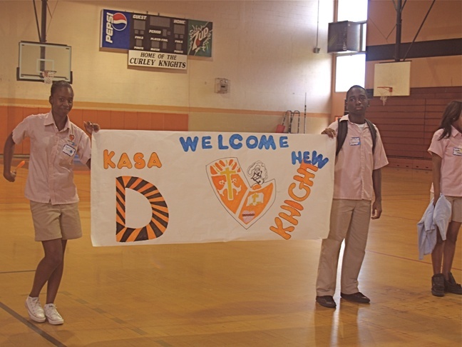 Student leaders Sophia Anilus, a senior, and Dukensley Raffael, a junior who came to Archbishop Curley Notre Dame High School in January after the earthquake in Haiti, welcome the new group of Curley Knights, the largest freshman class of the past several years, during orientation activities prior to the start of the 2010-2011 school year.