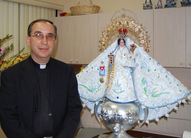 Msgr. Oscar Castaeda, rector of the National Shrine of Our Lady of Charity, poses with the image of Mary that will be taken from the shrine to the University of Miami Bank United Center on Sept. 8 for the annual celebration of the feast day of Cuba's patroness.