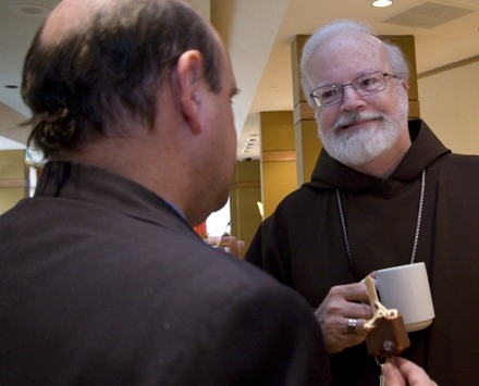 Boston Cardinal Sean O'Malley, a member of the U.S. bishops' Haiti Advisory Group, speaks to a participant Sept. 23 at the international gathering to discuss international coordination of Haiti relief efforts.