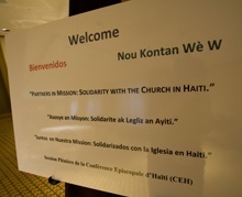 The sign welcomes participants to a plenary session of the Haitian bishops' conference, being held in Miami due to the large number of international participants.