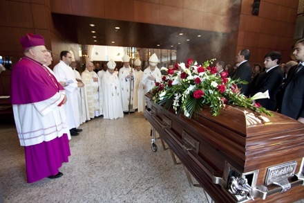 Archbishop Thomas Wenski watches as the body of Anthony Abraham is brought into Epiphany Church.