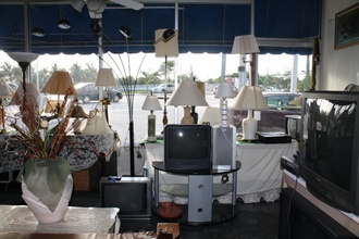 Lamps and televisions occupy one corner of the St. Vincent de Paul Society's thrift shop in Hialeah.