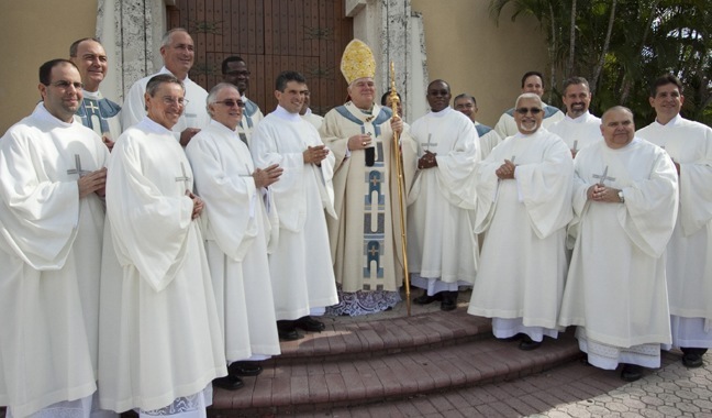 Newly-ordained deacons pose with Archbishop Thomas Wenski and others involved in their preparation for an official photograph at the end of the Mass.