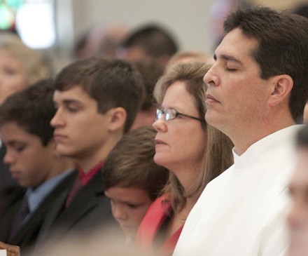 Jose Villena, his wife Linda, and their children, take part in the Mass.