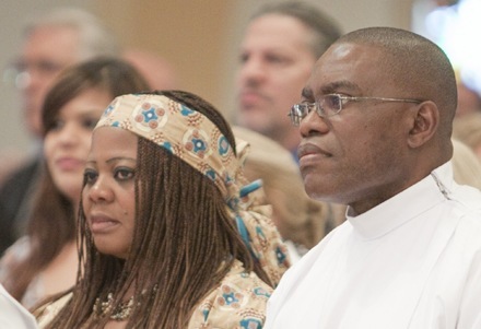 Soon-to-be-ordained Deacon Valentine Onuigbo and his wife, Philomina, take part in the start of Mass.