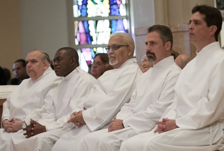 Before their ordination, the men listen to Archbishop Thomas Wenski's homily. From left: Gregory McLaughlin, Valentine Onuigbo, Antonio Perez-Noy, Timothy Smith and Jose Villena.