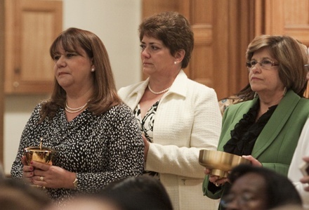 Deacons' wives take up the offertory, from left: Mercedes Perez-Noy, Heidi McLaughlin and Mayte Aleman.