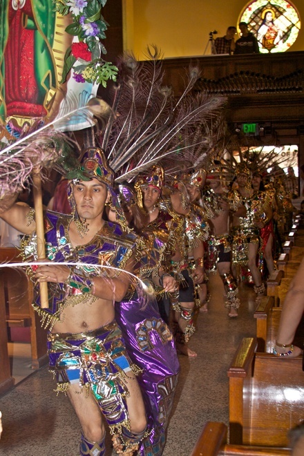 Above and below, representatives of the Aztec community dance and pay tribute to the Virgin of Guadalupe at the celebration of her feast day at Little Flower Catholic Church in Hollywood.