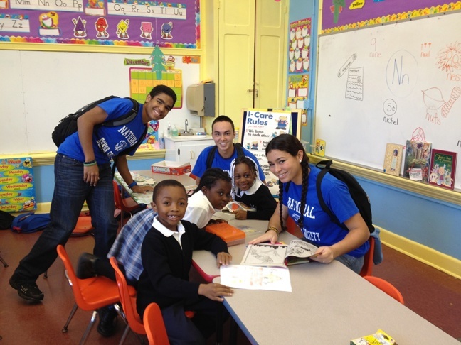 Students from Archbishop Coleman Carroll High School's National Honor Society have some coloring fun with St. Mary Cathedral students.