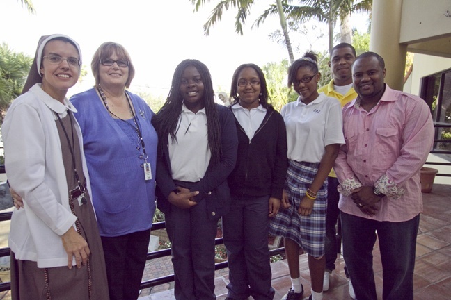 Visitors from St. Mary Cathedral School pose for a picture in the archdiocesan Pastoral Center, from left: Sister Michelle Fernandez, assistant principal; teacher Patricia Cunningham; students Shellbie Charles, Briana Gaspard and Keyanna Francois; and alumni Frantzy Gaspard and David Adelson.