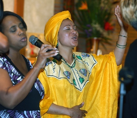 Choir member Patience Nkuba sings with other choir members.