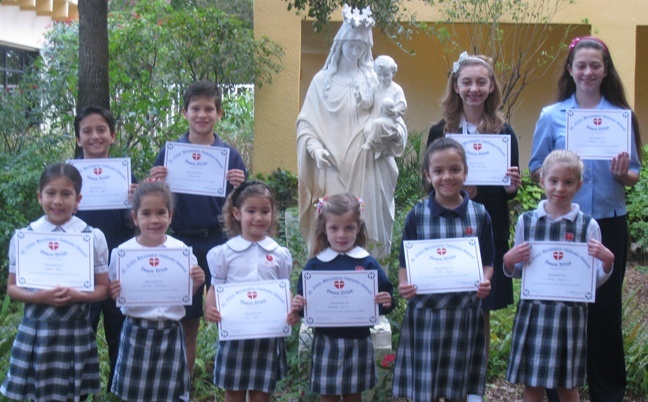 In honor of Martin Luther King Day, St. John Neumman School awarded its first annual Peace Prize as part of the school's Bullying Awareness and Prevention program. The Peace Prize was awarded to the students voted by their classmates as having done the most to promote peace and kindness in the school. One Peace Prize was awarded per grade. Pictured, left to right, back row: Alejandro Aguirre, Jonathan Rose, Sofia Fernandez, Catherine Lamey (Ryan Sanchez is not pictured); front row: Sophia Mesa, Isabella Fernandez, Antonella Liviero, Mia Pujol, Cecilia Seiglie, and Emily Chaffins.