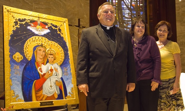 Archbishop Thomas Wenski poses with Sharon Miller and Mary Lou La Macchia, daughters of Dolores Murphy, in honor of whose life the icon was created.