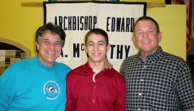 From left to right: Archbishop Edward A. McCarthy High School head wrestling coach Joe "Bert" Bertolone, national wrestling champion Javier Rodriguez, and volunteer assistant coach Mike Turner.