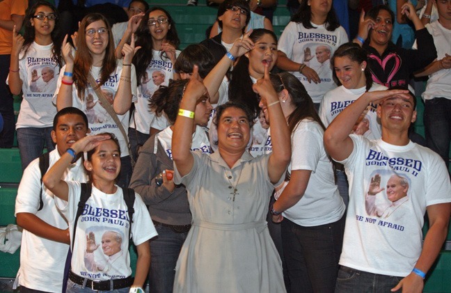 Sister Olga Villar, a Claretian nun, who organized the youth vigil joins youths singing "Waves of Mercy" performed by "Joyful Noise" musical group from Our Lady of Lourdes Church.