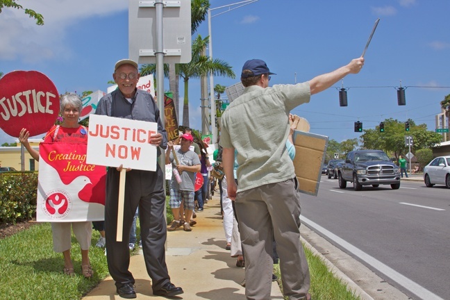 Father Roger Holoubek, center, joins the parishioners of St Maurice, members of the Coalition of Immokalee Workers and members of the group Interfaith Action to protest the low wages being paid to Florida's farmworkers.