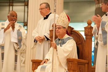 Bishop Estevez sits in his bishop's chair for the first time after the apostolic mandate was read. The precious miter worn by Bishop Felipe Estevez was a gift from Archbishop Thomas Wenski and the Archdiocese of Miami.