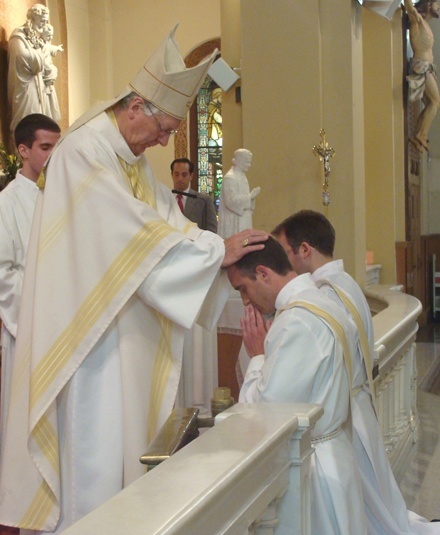 Salesian Bishop Luc Van Looy of Ghent, Belgium, lays hands on Deacon Matthew DeGance, ordaining him a "priest forever."