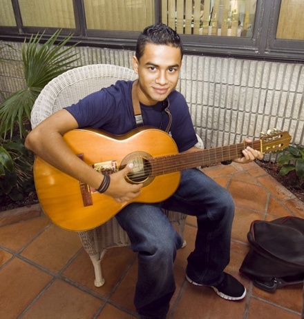 Johnny Gonzalez, 17, of Mother of Christ Parish in Miami, plays his guitar while waiting for Archbishop Thomas Wenski to give him and nearly 200 other World Youth Day pilgrims a farewell blessing.