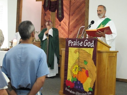Deacon Ralph Gazitua proclaims the Gospel.