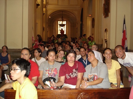 Miami pilgrims to World Youth Day sit in a Madrid church to listen to a Spanish-language catechesis by the retired bishop of Pamplona, Spain. Catechesis by bishops from around the world led up to the papal events at World Youth Day.