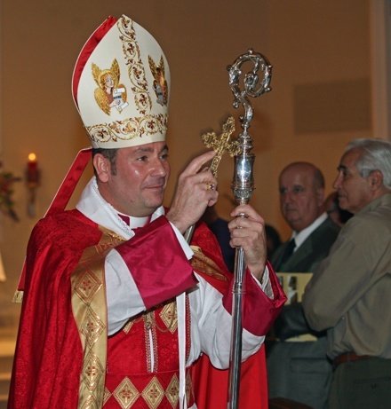 Chorbishop Michael Thomas blesses the congregation during the recessional at the end of Mass.