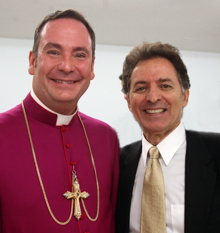 Chorbishop Michael G. Thomas poses for a photo with Thomas Abraham, son of Anthony Abraham. The Anthony R. Abraham Foundation is donating ####_L_ million to Heart of Jesus Maronite Catholic Church.