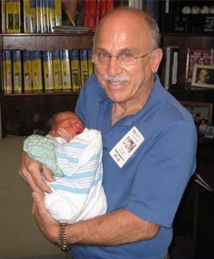 Nick Silverio, a knight of Malta and founder of Safe Haven for Newborns, poses with one of his success stories, baby Vincent, born in 2007 and placed for adoption.