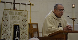 Father Joaquin Rodriguez, pastor of St. Martin de Porres Church, preaches the homily to his parishioners during the Mass.