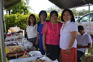 Manning the Filipino booth at the international food festival that followed the Mass and procession, from left: Jeannine Pollock, Luz Armas, Norma Vengco and Alice Alaan. Food from Puerto Rico, Mexico, the Dominican Republic and Mexico also was on the menu.