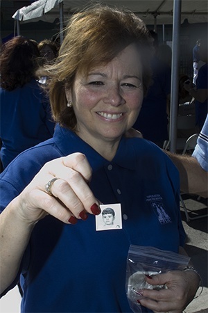 Maria Teresa Gomez Lombardi shows a picture of herself at age 6, when she arrived in Florida City as an unaccompanied minor under the Pedro Pan program.