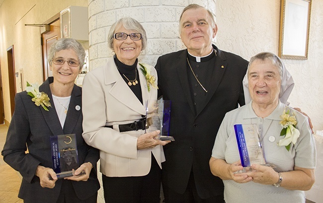 Posing with Archbishop Thomas Wenski after the Mass, from left, the recipients of the Lifetime Catechetical Leadership awards: Anne Gardner of St. Sebastian Parish in Fort Lauderdale; Pat Solenski of St. Anthony Parish in Fort Lauderdale; and Claretian Sister Carmen Alvarez of Corpus Christi Parish in Miami.