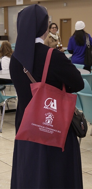 A Daughter of Charity waits in line for coffee while holding her "goody" bag.