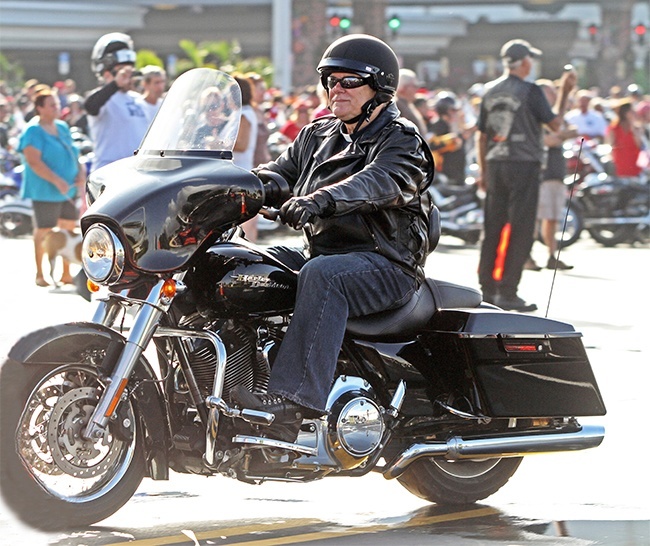 Archbishop Thomas Wenski rides out on his Harley Davidson, one of thousands of motorcyclists who took part in this year's Toys in the Sun Run.