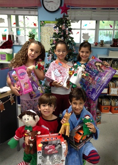 St. Agnes second graders join in the giving spirit by donating toys for needy children.