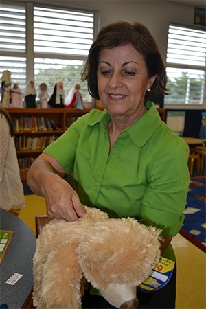 Isabel Taja, kindergarten assistant, places the heart in her bear.