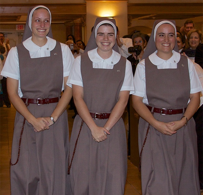 Sister Clara Maria of the Visitation, Sister Lucia Maria de Jesus Sediento en la Cruz and Sister Ana Laura de Maria, Madre del Amor Fiel, re-enter Blessed Trinity Church dressed in their new habits.