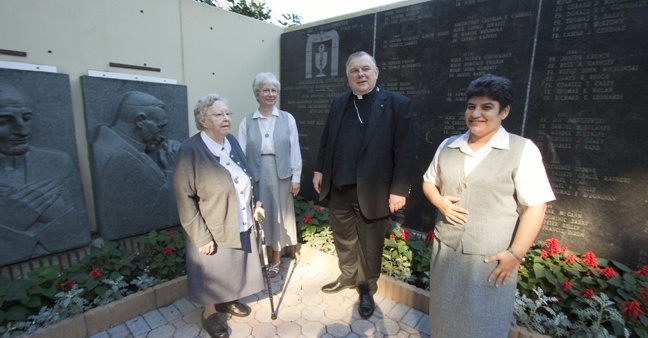 The general moderator of the Sisters of Social Service, Sister Agnes Pataki (second from left), visited members of her community in South Florida this month and stopped by the Pastoral Center Jan. 24 to meet with Archbishop Thomas Wenski. Pictured here in the Garden of Memories at the Pastoral Center is the archbishop with Sister Pataki, Sister Suzanne Simo (far left), a retired sister living in the archdiocese who worked for 30 years at Centro Hispano Catolico in Miami, and Sister Yillian Gonzalez, one of 19 Sisters of Social Service working in Cuba. Sister Gonzalez, who works in El Cobre, was visiting her family in Miami. Another member of the community, Sister Irmina Rojas, also is retired in Miami but continues to volunteer at Centro Mater, where she served for many years. The archbishop was showing Sister Pataki the plaque honoring Cardinal Jzsef Mindszenty, who suffered under communism in Hungary. Sister Pataki is a native of Hungary. The memorial plaques were commissioned by Archbishop Joseph P. Hurley of St. Augustine back when Miami was part of that diocese, and scuplted by Yugoslavian artist Ivan Mestrovic.